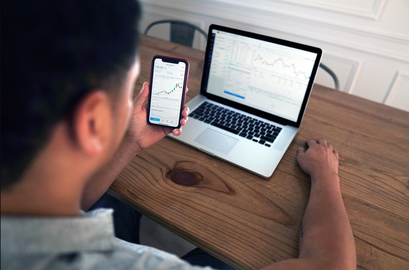 a futuristic graphic depicting a person interacting with a holographic interface showing financial data and insights