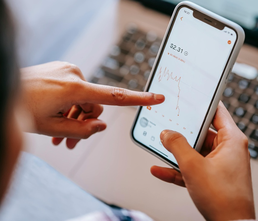 smartphone screen showing a friendly chatbot icon interacting with a user